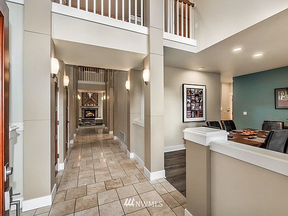 Inviting entry with vaulted ceilings and formal dining to the right but what your eye will catch is the amazing fireplace in the great room. It truly draws you in!