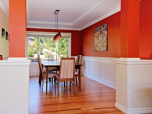 Dining Room with view of back yard. Formal wainscoting.