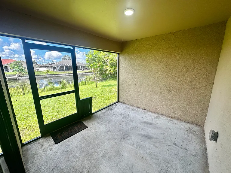Screened back lanai with doggy door to the fenced back yard and canal.