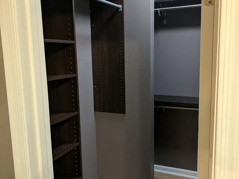 Large walk-in bedroom closet with custom storage shelving.