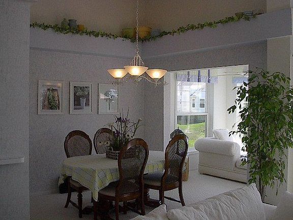 Formal Dining Room with ceiling ledge and entry to Sun Room.