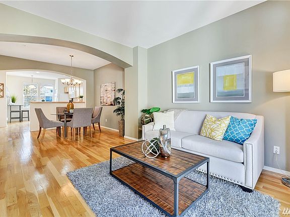This meticulously cared for townhome features a bright living room with expansive hardwood floors throughout.