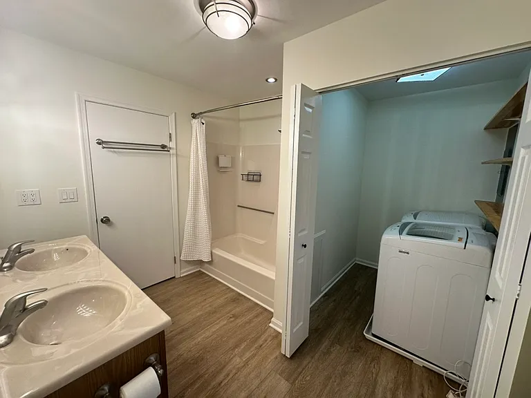 Second spacious bathroom with view into the laundry room.