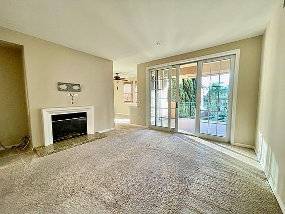 living room with fireplace and balcony access