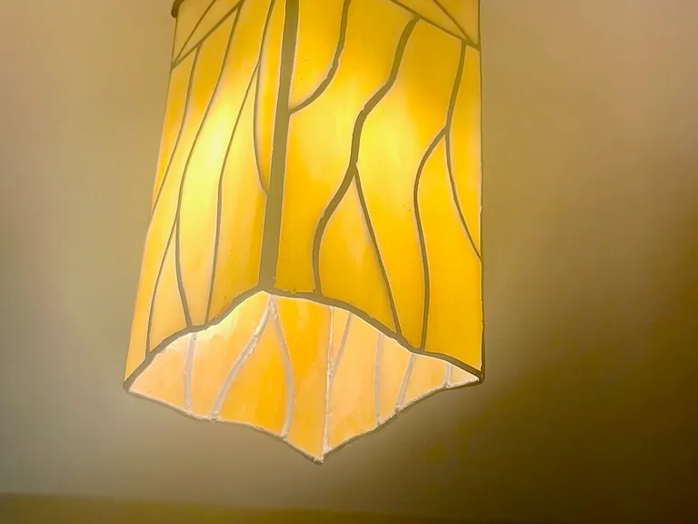 Stained glass entryway light creates a warm and welcoming light