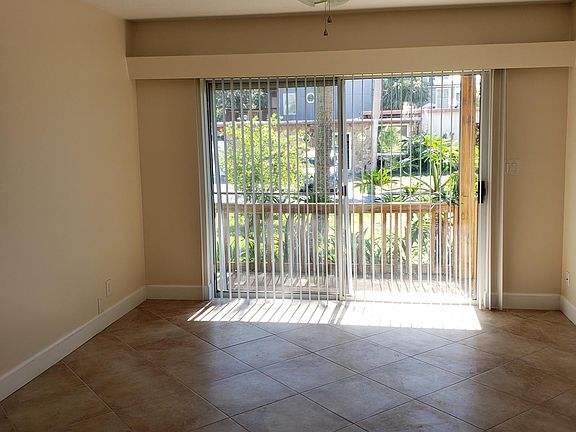 View front door through kitchen and living/dining area. 8 ft sliders.