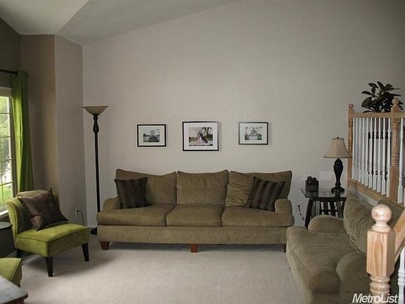 The formal living room looks out to the front yard.  The volume ceiling adds to the spacious feeling of the room.