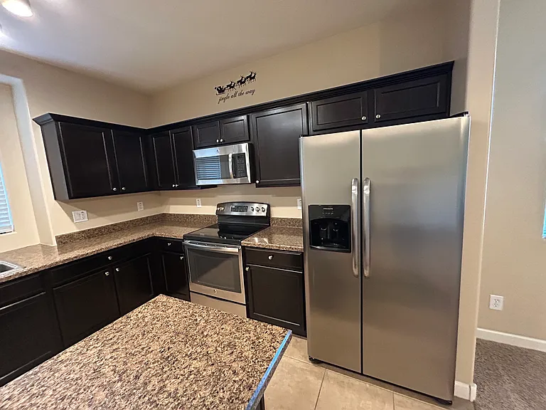 Bright kitchen with GE stainless steel appliances