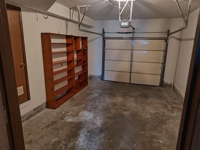 One car garage, with insulated door, storage shelves.