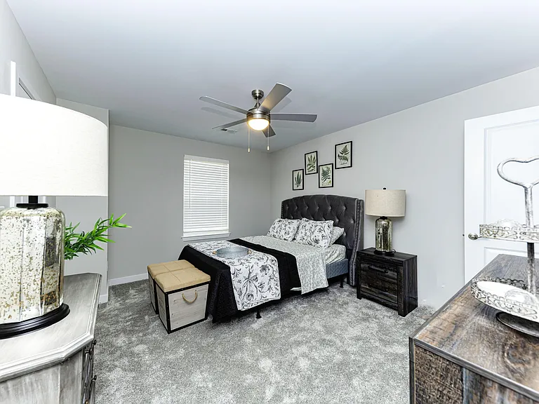 Cozy bedroom with carpet & ceiling fan