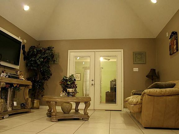 French doors lead to an extra room that can be used as a gameroom or flex space