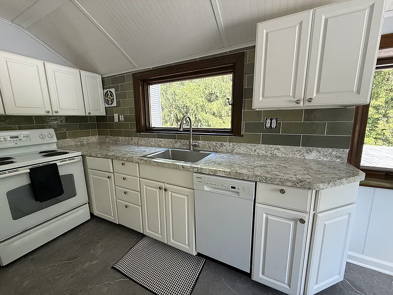 Updated, eat-in kitchen with beautiful windows and pantry.
