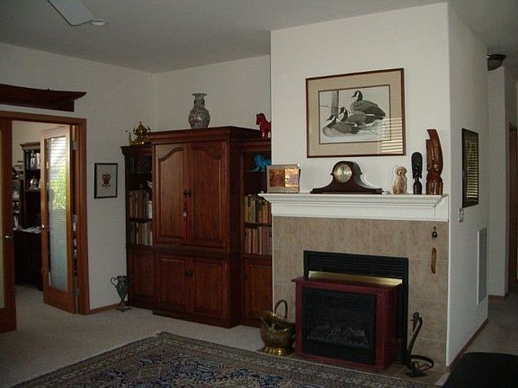 Large area for an entertainment center, built in or cabinet. Gas fireplace with a mantle.