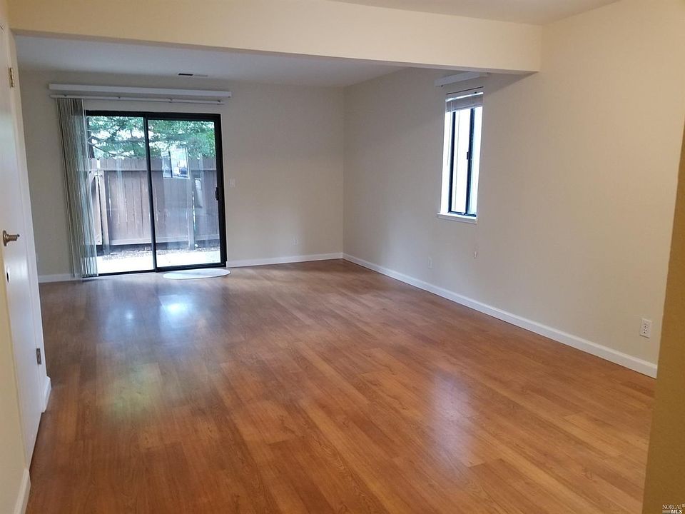 End unit allows extra light. Freshly painted interior. Living room/dining room leads out to private patio with Redwoods. Large s