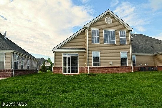 Rear of similar unit, 2 story living room windows.