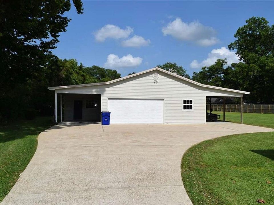 The front of the barndominium. The door on the left under the carport is entrance into the apartment. Garage parking with door inside garage to enter home too. It has updated nice hot water heater.