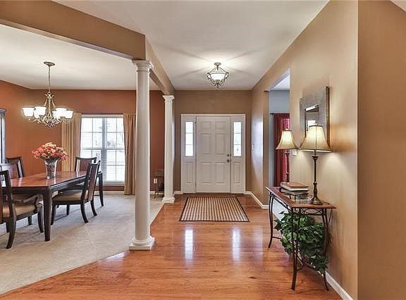 Open formal entrance hall with wood floor