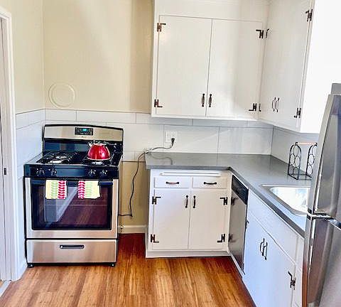 Kitchen has stainless appliances, gas stove and stone countertops