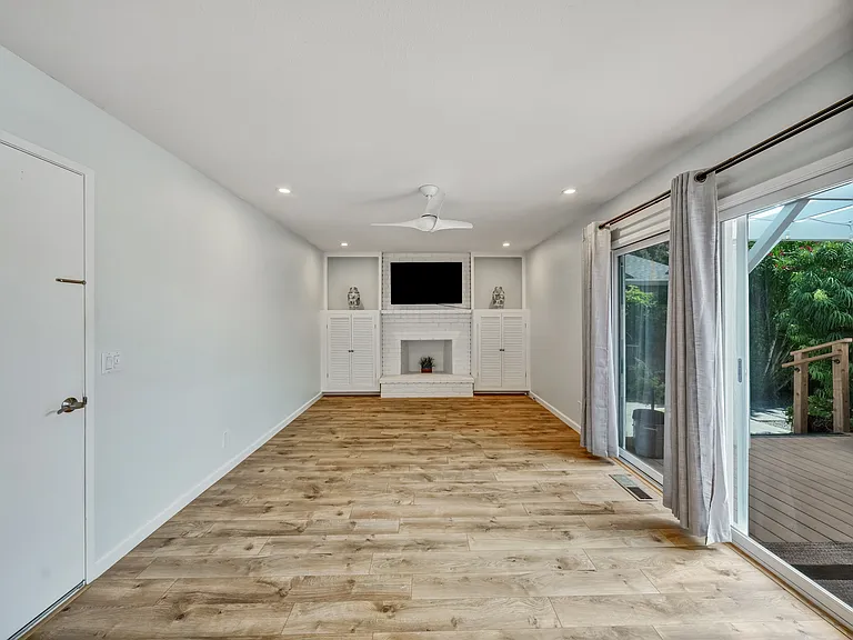 Family room (opens to deck) with decorative fireplace.