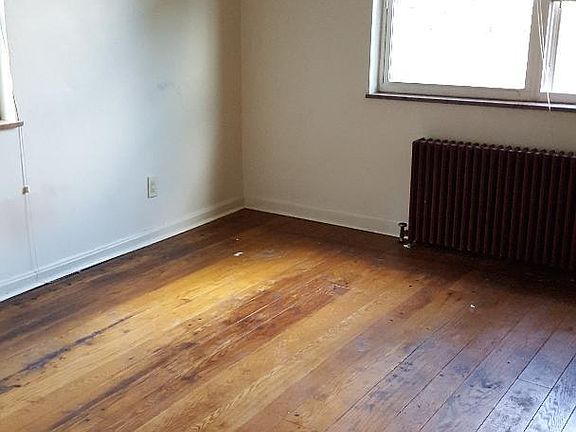 Living room with re-glazed hardwood floors in 2018.