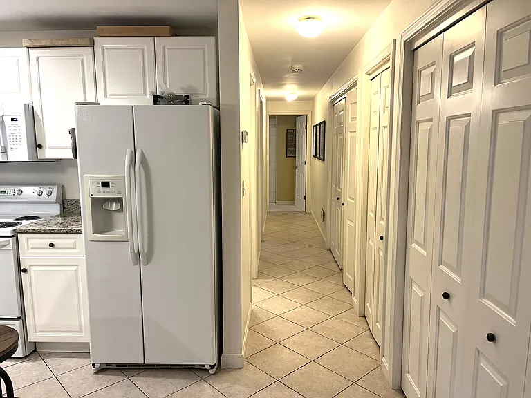 Corridor to bathroom, bedroom (left) and office at the end of the corridor. On the right is a storage closet, pantry and washer & dryer.