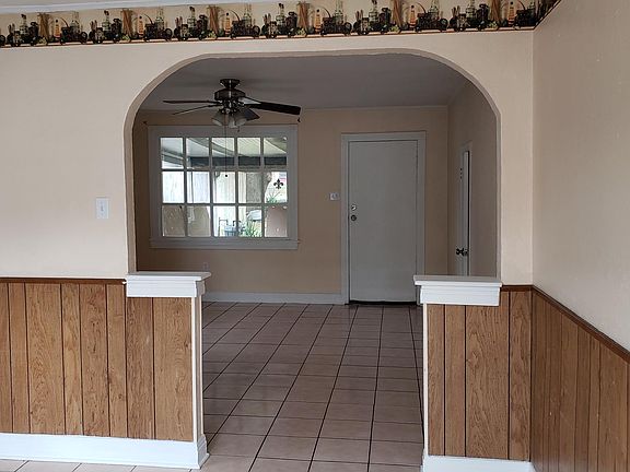 Living room has ceiling fan.