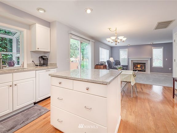Open concept kitchen with crisp white cabinetry