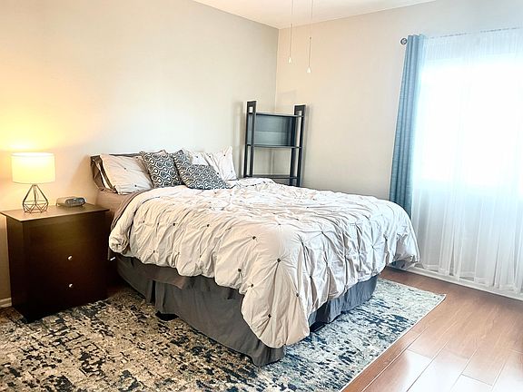 Queen size bed with mattress topper