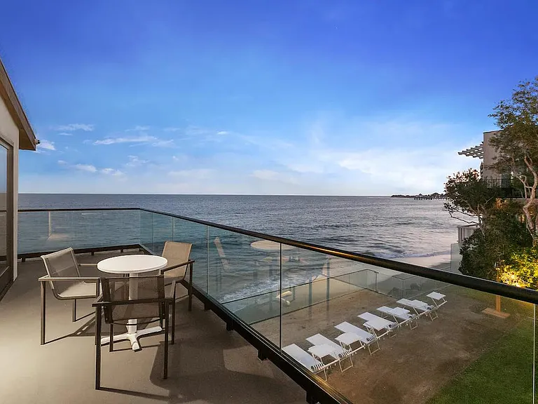 With your sparkling champagne in hand, watch the sunset dim the sky from your private balcony space