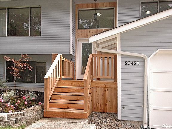 Enter into your nearly new interior home.  A brand new front porch and door and siding on the front of the home!