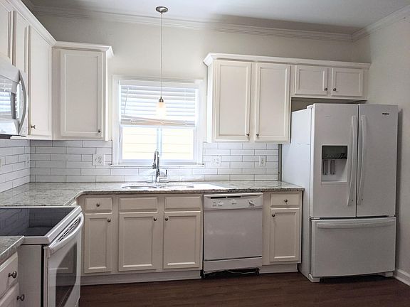updated kitchen with granite countertops, subway tile backsplash and recently painted cabinets.