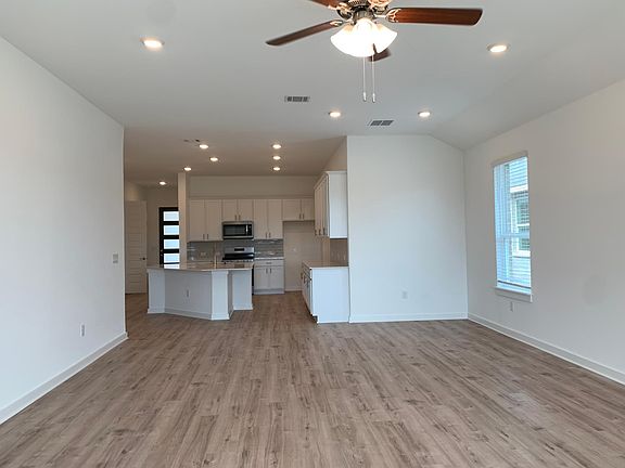 Spacious living area with open floor plan (Samsung fridge included, not pictured here)