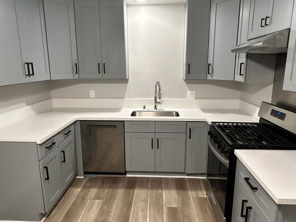 Brightly lit kitchen with new oven and kitchen (new dishwasher to the left of the sink will be installed prior to move in)