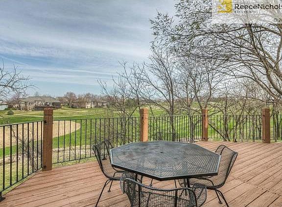 Walkout to a HUGE deck with metal railing overlooking the 10th h