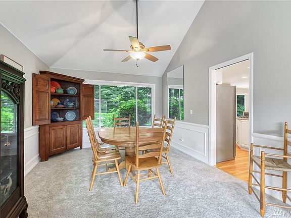 Formal dining room also features wainscoting and vaulted ceiling.