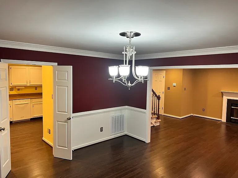 View from the Dining room into the kitchen (left) and Family room (right). Walls have been repainted to neutral color.
