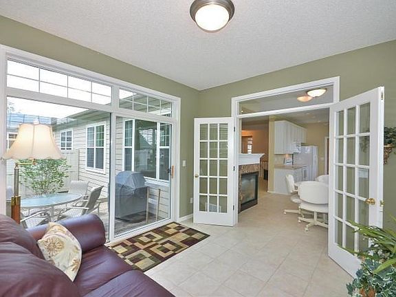 Sun Porch looking on to patio and dining area note the class doors