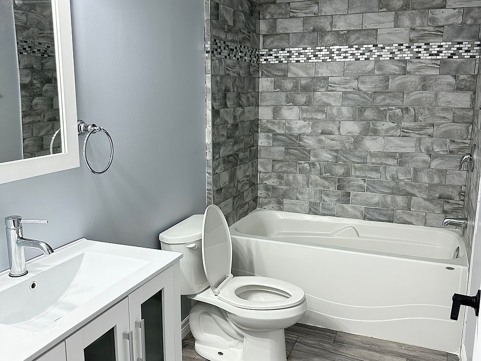 Renovated bathroom with deep bathtub and modern vanity
