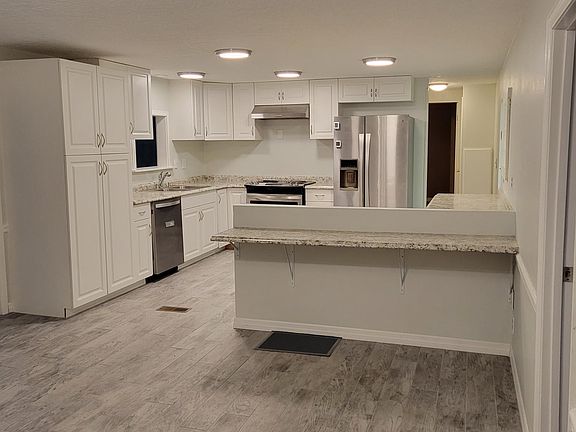 View of dining room to kitchen showing new tile flooring