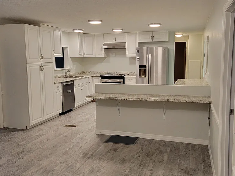 View of dining room to kitchen showing new tile flooring