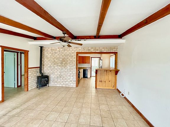 Gorgeous open living area and the kitchen, creating an open layout that seamlessly, connects the two spaces.