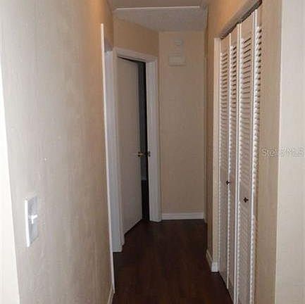 Hallway leading to bedrooms and bathroom with large closet with plenty of storage space