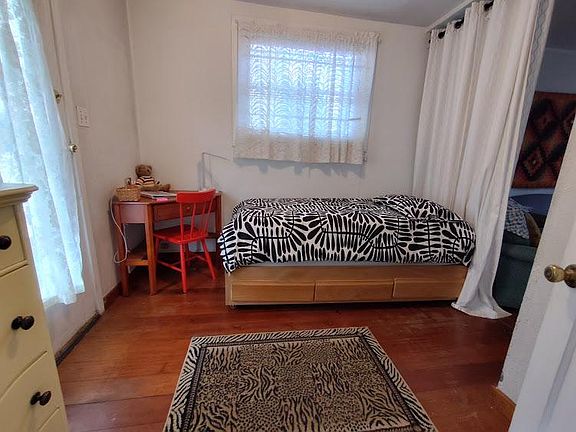 Sun filled room. Captain's bed - single bed with drawers below.