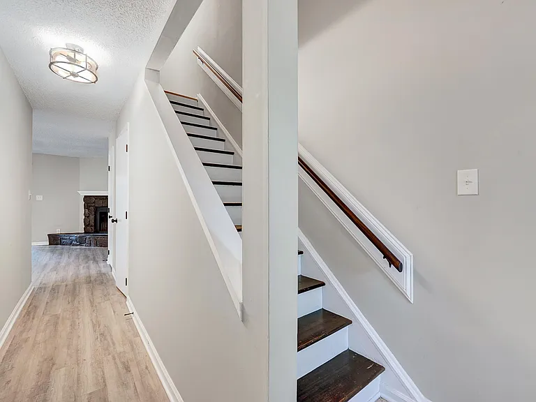Walking in through the front door you have the stairs, a coat closet and a half bathroom