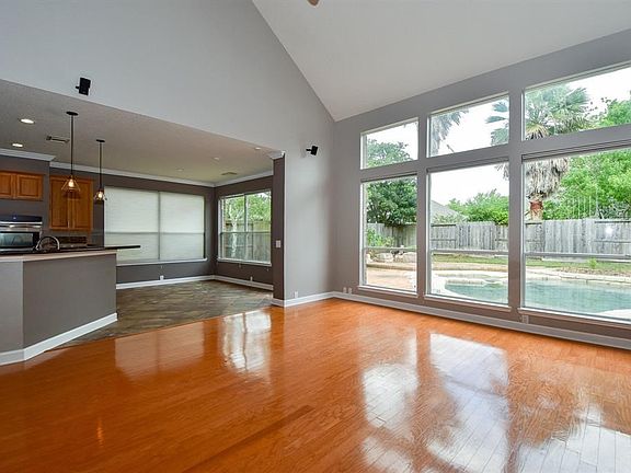 Welcome to the great family room.  Hardwood floors and large windows with views of the pool