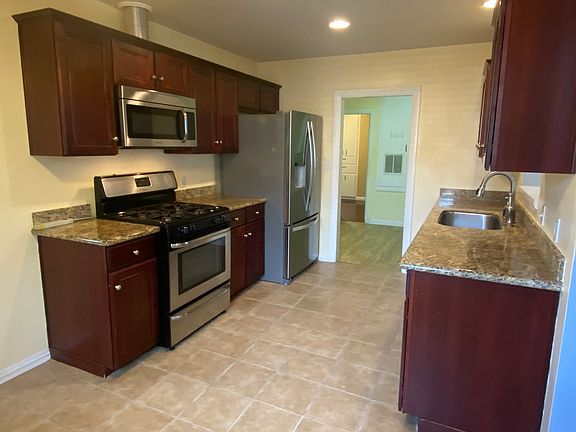 Granite counter, stainless steel appliances and gas stove.