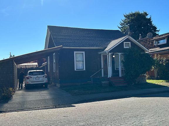 Street view of house with carport.