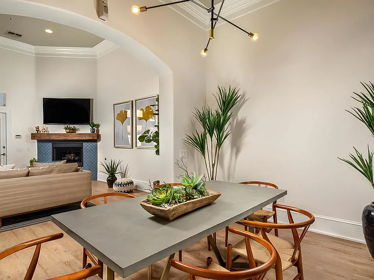 Resident Clubroom Featuring Fireplace, TV, And Community Table