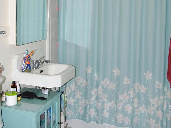 Bathroom with shower over tub.