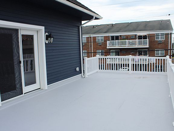 French doors from open concept living room lead to HUGE private outdoor deck.